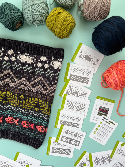 Finished sample cowl with pattern cards used to make sample from Summer Doodle Deck