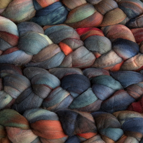 4 oz braid of unspun merino wool top in the Pocion colorway, blue/red/orange/green/brown roving hand dyed