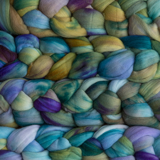 4 oz braid of unspun merino wool top in the Indiecita colorway, Blue/green/yellow/purple roving hand dyed