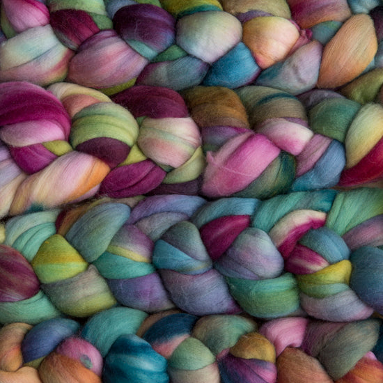 4 oz braid of unspun merino wool top in the Arco Iris colorway, pink/purple/orange/green/blue/yellow roving hand dyed