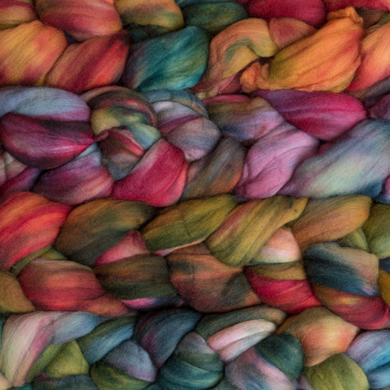 4 oz braid of unspun merino wool top in the Diana colorway, green/blue/orange/pink/purple/yellow roving hand dyed