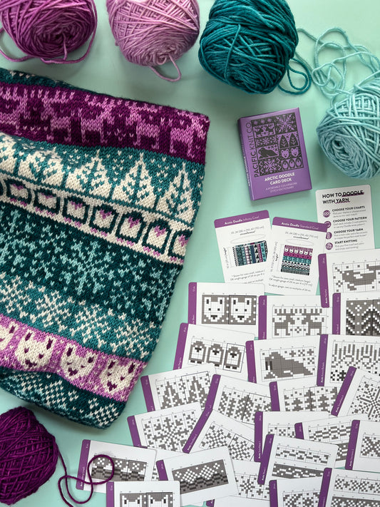 Arctic Doodle Deck finished sampler next to pattern cards included in deck